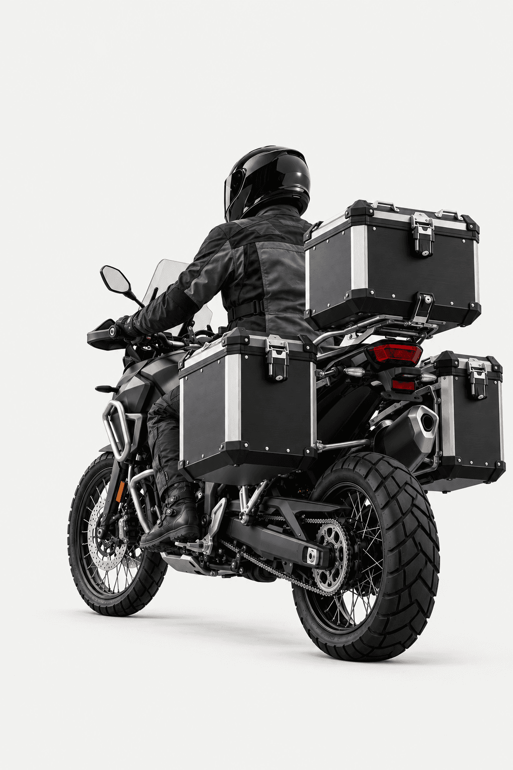 Rider on a black adventure motorcycle fitted with aluminium top box and side cases, seen from behind